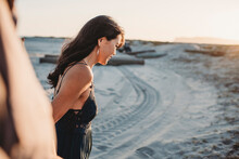 Side View Of Beautiful Woman With Long Dark Hair At The Beach