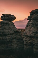 Poster - Mesmerizing view of the rock formations on the background of the pink sunset in a vertical shot