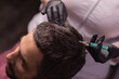 Mesotherapy for hair. Attractive man receiving injections in his head. Man having mesotherapy session at beauty salon, therapist in protective glove with syringe,