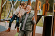 © BGStock72 - Grandfather spending time with his granddaughter in park playground on autumn day