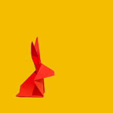 Creative Greeting Card Design Made Of Red Paper Rabbit On A Vibrant Yellow Background. Lunar, Chinese New Year Composition For 2023. Year Of The Rabbit.