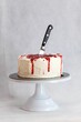 designer chef decorating white red bloody horror crime cake for halloween party