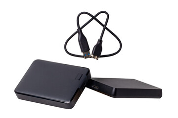 Two external hard drives from large capacity and a USB cable for connected to laptop for backing up files and important information isolated on white. Portable hard drives for data backup. Macro.