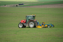 Massey Ferguson 5711 DYNA Tractor With Rear Grass Cutter Mowing A Field