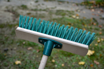 Green plastic broom .