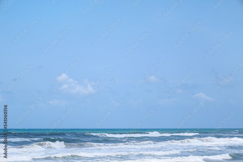 View of beautiful sea and sky with flying airplanes