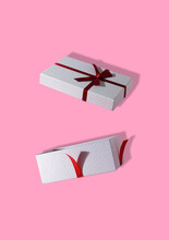 Open Gift Package, Creative Holiday Concept, Pink Background

