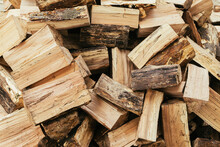 Firewood. Stack Of Firewood Close Up, Wooden Background. Chopped Wood For Fireplace Heating, Alternative To Gas And Electricity. Lumber Pattern, Log