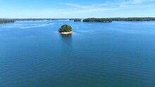 Lake Lanier In North Georgia, 4K Aerial Drone Footage. Radiant Clouds Both Blue And White. Clear View Of Fall Colored Trees And Blue Lake Water. Flying Over Small Island