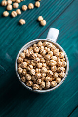 Wall Mural - Roasted, yellow chickpeas in a cup. Top view.