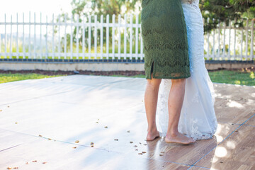 legs of bride and her mother slow dancing