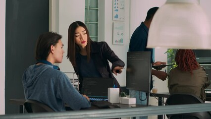 Team of database admins analyzing source code on computer monitor, comparing data script in busy agency office. Two cloud programers debugging algorithm in software developing office.