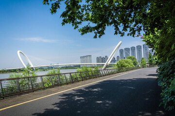 Wall Mural - Modern city park and bridge in the distance