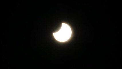 Wall Mural - partial solar eclipse with a clear sky and no clouds - oct. 25, 2022