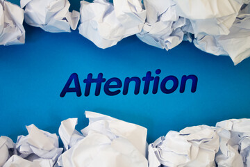 Poster - Attention text with Torn, Crumpled White Paper on colored background.