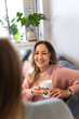 © Austockphoto - Close up shot of a smiling woman holding a white mug with pride symbol