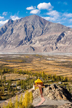 Gazebo With Yellow Roof At Nubra Valley, Leh, Ladakh, India With High Mountain Under The Blue Sky Scene.