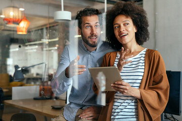 Smiling diverse colleagues gather in boardroom brainstorm discuss financial statistics together