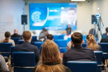 Canvas Print - Businesspeople watching online conference in auditorium