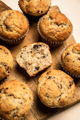 Wall Mural - Chocolate banana muffins on a wooden board, top view