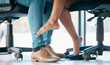 Feet, flirt and affair with a work romance between and business man and woman in the office together. Couple, shoes and love with a male and female flirting under a table at work in infidelity