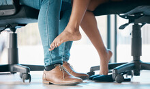 Feet, Flirt And Affair With A Work Romance Between And Business Man And Woman In The Office Together. Couple, Shoes And Love With A Male And Female Flirting Under A Table At Work In Infidelity