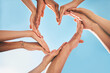 © J Bettencourt/peopleimages.com - Heart, love and group hands for support, care and community with outdoor summer sunshine, blue sky and mock up. Group of people with care sign for solidarity, health and wellness background mockup