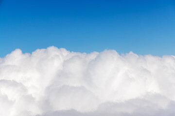 Wall Mural - sunny clouds and sky from airplane