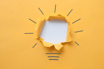 Wall Mural - Torn paper light bulb background concept