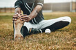© Allistair F/peopleimages.com - Baseball, player and stretching for game, training and workout on field, with ball and sportswear for health. Black man, athlete or doing exercise to prepare for game, match or fitness being healthy