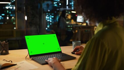 Poster - specialist writing corporate project plan on laptop computer with green screen mock up display. conf