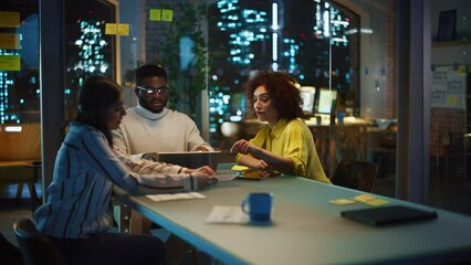 Poster - Positive Group of Managers Having a Team Meeting Long After Work Hours in the Night. Inspired Colleagues Discussing Annual Financial and Marketing Reports. Teamwork in Creative Office.