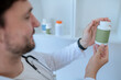 © zinkevych - Doctor reading the label on a dietary supplement