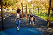 © ADDICTIVE STOCK - African American mother and daughter on swings