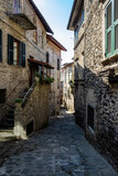 Fototapeta Uliczki - View down an old street/alley in Pontremoli, Italy