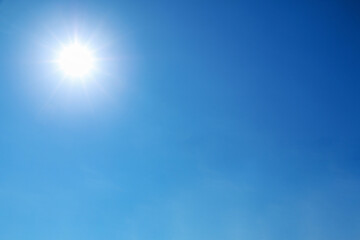 bright sun shines on clear blue sky