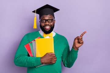 Portrait of excited student graduate from university promote recommend his high school isolated on violet color background