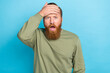 Photo of forgetful handsome guy with ginger hairstyle khaki long sleeve arm on forehead open mouth isolated on teal color background