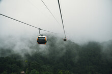 Cable Car Climbing Up To Foggy Hill Over Thick Forest In Banahill, Danang, Vietnam