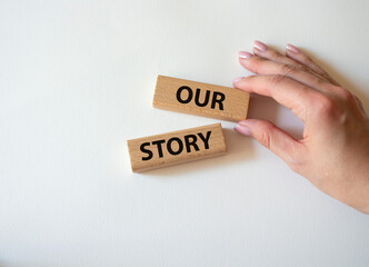 Our story symbol. Wooden blocks with words Our story Beautiful white background. Businessman hand. Business and Our story concept. Copy space.