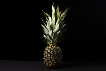 Poster - Pineapple on a black background. Tropical Fruit