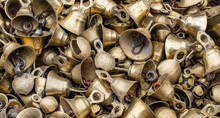 Closeup Shot Of A Textured Background With A Pile Of Rusty Old Bells For Wallpapers