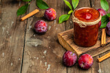 Fototapeta Mapy - Jar with homemade plum jam on a wooden background. banner, menu, recipe place for text