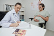 © DragonImages - Gynecologist Filling Medical Form