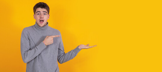 Poster - isolated young man pointing surprised