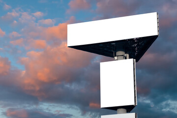 Wall Mural - two blank white billboards against warm sunset sky with clouds - mock up. consumerism, advertising, 