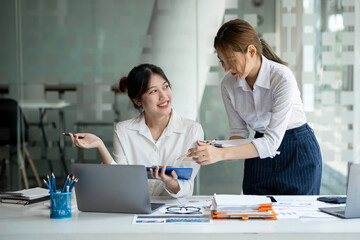 Wall Mural - Businessmen holding pens and graph paper are meeting to plan sales to analyze investment results and profits for the growth of the company.