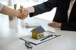 © crizzystudio - Successful deal Real estate lease or home purchase concept buyer shakes hands with bank employee after office contract is completed.