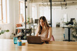 © Nadya - Work Time in Startup - Young Woman Sitting and Working On The Table with Laptop From Office