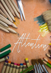 Poster - Overhead shot of school supplies with Attention text. Brushes, pencils, artistic tools. Art And Craft Work Tools.